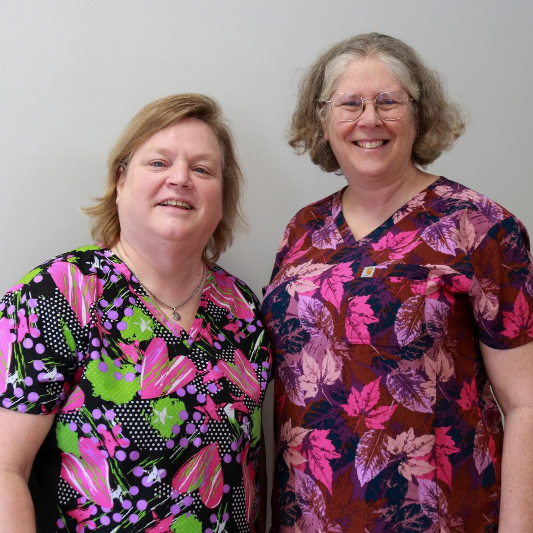 two people in scrubs standing next to each other